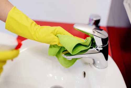 Hygiene-focused office cleaners sanitising shared workspace surfaces